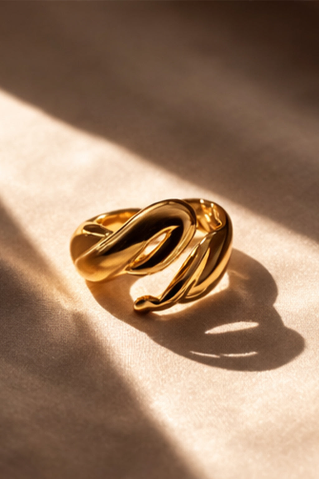 Gold ring on a beige fabric background