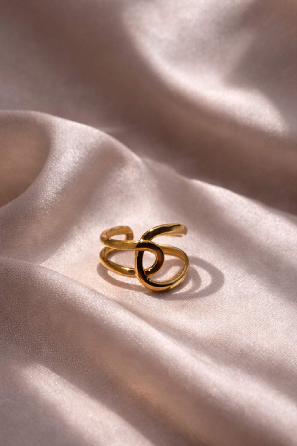 Gold ring on a soft, light fabric background